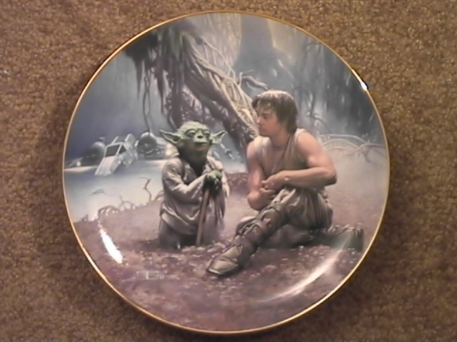 A picture of a plate with Yoda and Luke on it