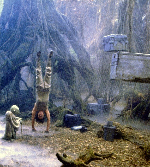 Luke levitates boxes, Yoda looks on