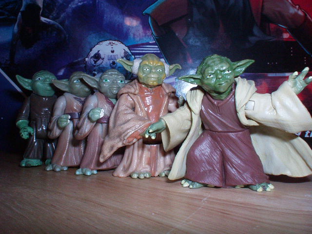 Five different Yoda figures (vintage Empire Strikes Back to Attack of the Clones