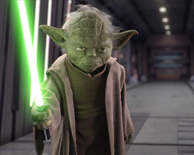Yoda with his lightsaber raised in Palpatine's office
