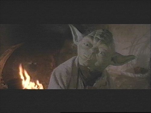 Yoda by a fireplace
