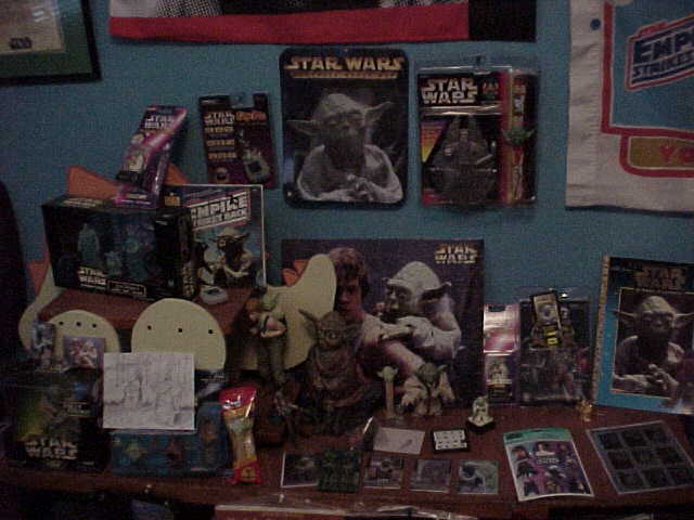 A table full of Yoda collectibles