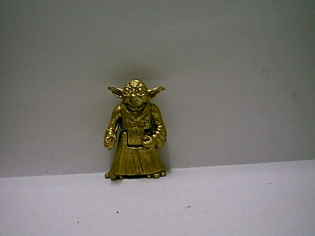 A bronze Yoda that looks like a Power of the Force (1995) Yoda toy
