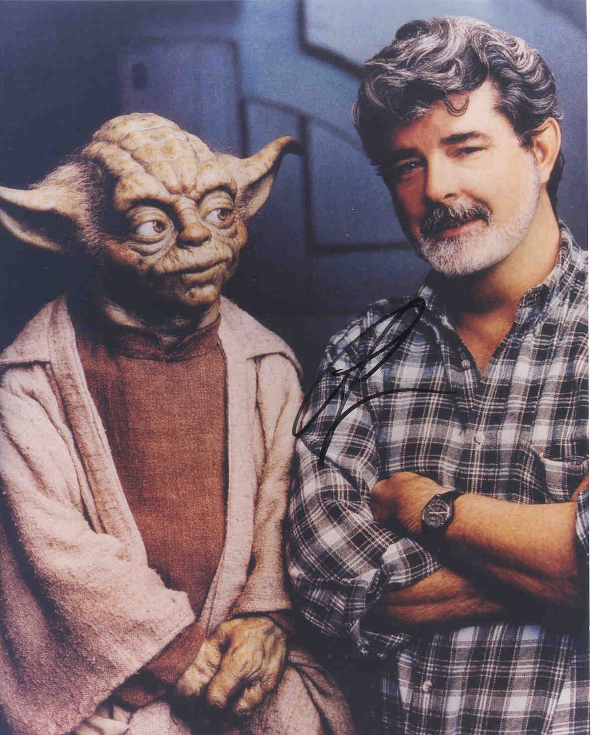 A picture of Yoda and George Lucas autographed by Lucas