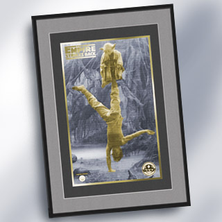 Gold plated card with Yoda balancing on Luke's leg